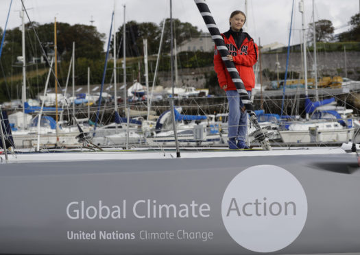 Greta Thunberg poses for a picture on the boat Malizia as it is moored in Plymouth, England Tuesday, Aug. 13, 2019.