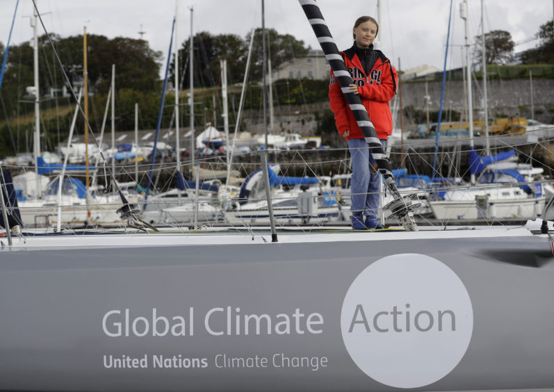 Greta Thunberg poses for a picture on the boat Malizia as it is moored in Plymouth, England Tuesday, Aug. 13, 2019.