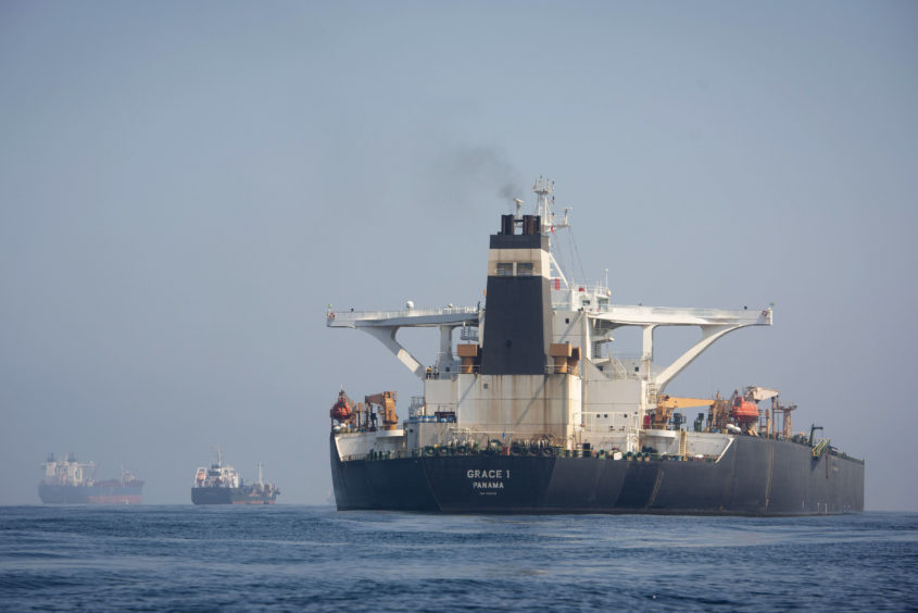 A view of the Grace 1 supertanker at anchor in the British territory of Gibraltar, Thursday, Aug. 15, 2019, seized last month in a British Royal Navy operation off Gibraltar.  The United States moved on Thursday to halt the release of the Iranian supertanker Grace 1, detained in Gibraltar for breaching EU sanctions on oil shipments to Syria, thwarting efforts by authorities in London and the British overseas territory to defuse tensions with Tehran.(AP Photo/Marcos Moreno)