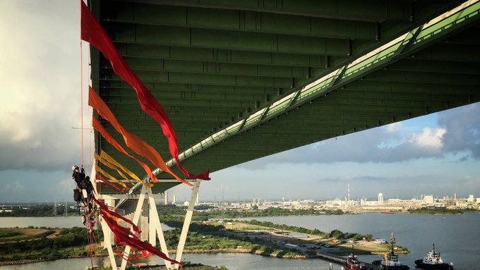 The Houston Ship Channel was partially shut Thursday after Greenpeace activists suspended themselves from a bridge spanning the key oil route in protest against the fossil fuel industry. Photo credit: Greenpeace USA