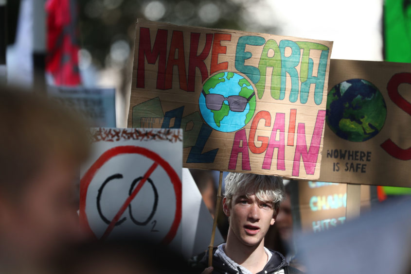 A protester at the UK Student Climate Network's Global Climate Strike in London. PA Photo. Picture date: Friday September 20, 2019. Young climate strikers across the country are taking to the streets as part of a global protest to demand urgent action to tackle climate change. Gareth Fuller/PA Wire