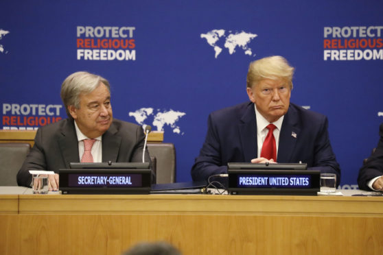 President Donald Trump listens at an event on religious freedom during the United Nations General Assembly, Monday, Sept. 23, 2019, in New York, with UN Secretary General Antnio Guterres, left. (AP Photo/Evan Vucci)