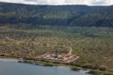 Aerial shot of a drilling rig on the side of a lake