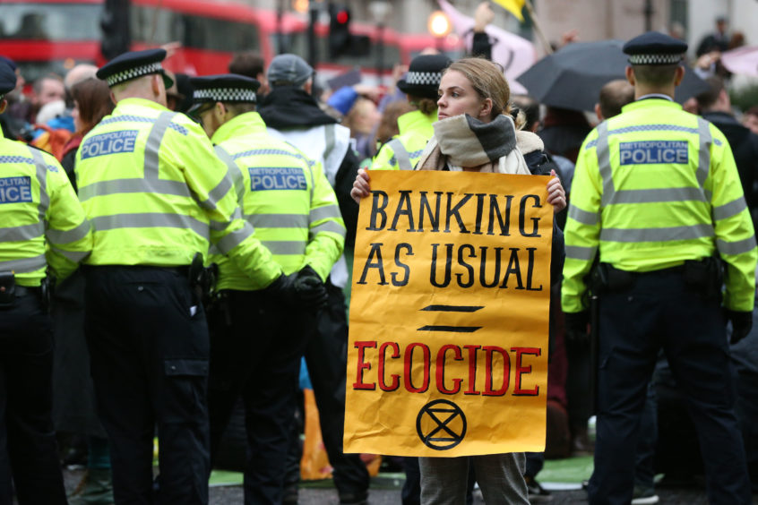 Protesters block the road outside Mansion House in the City of London, during an Extinction Rebellion (XR) climate change protest. PA Photo. Picture date: Monday October 14, 2019. See PA story ENVIRONMENT Protests. Photo credit should read: Jonathan Brady/PA Wire