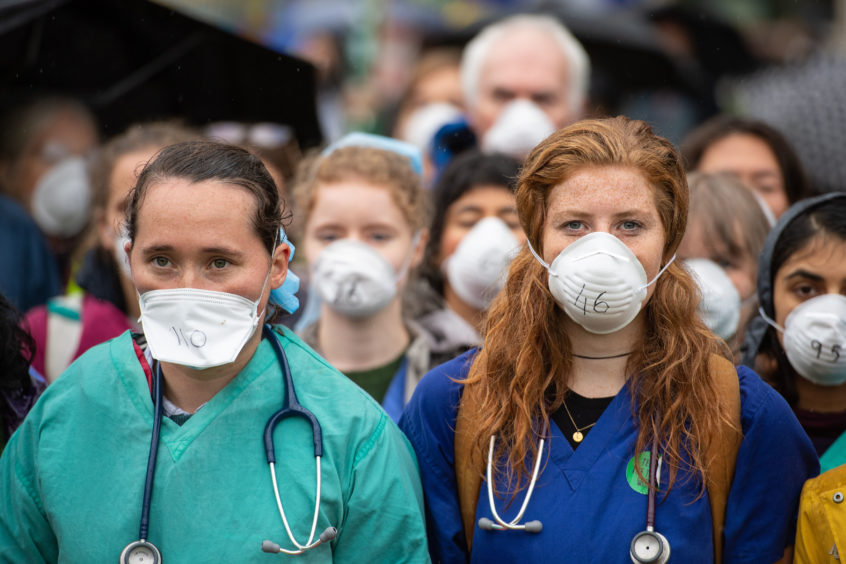Doctors gather to protest in support of Extinction Rebellion (XR) at Jubilee Gardens, London, to highlight deaths caused by air pollution.  Dominic Lipinski/PA Wire