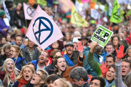Protesters sitting down outside the Ministry of Justice in Westminster, London, during an Extinction Rebellion (XR) climate change protest. PA
