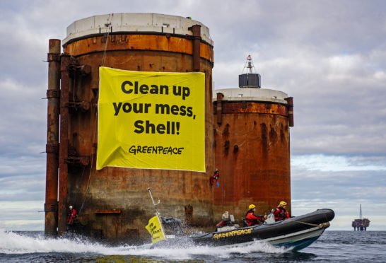 Climbers, supported by the Greenpeace ship Rainbow Warrior, scaled Brent Alpha and Bravo and hung banners saying, ‘Shell, clean up your mess!’ and ‘Stop Ocean Pollution’. Pic: Greenpeace