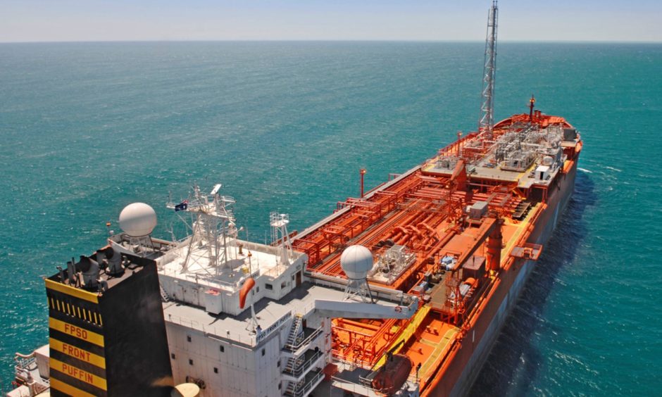 An FPSO floats on a blue sea