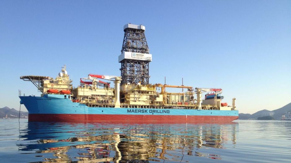 A drillship on the water with a reflection