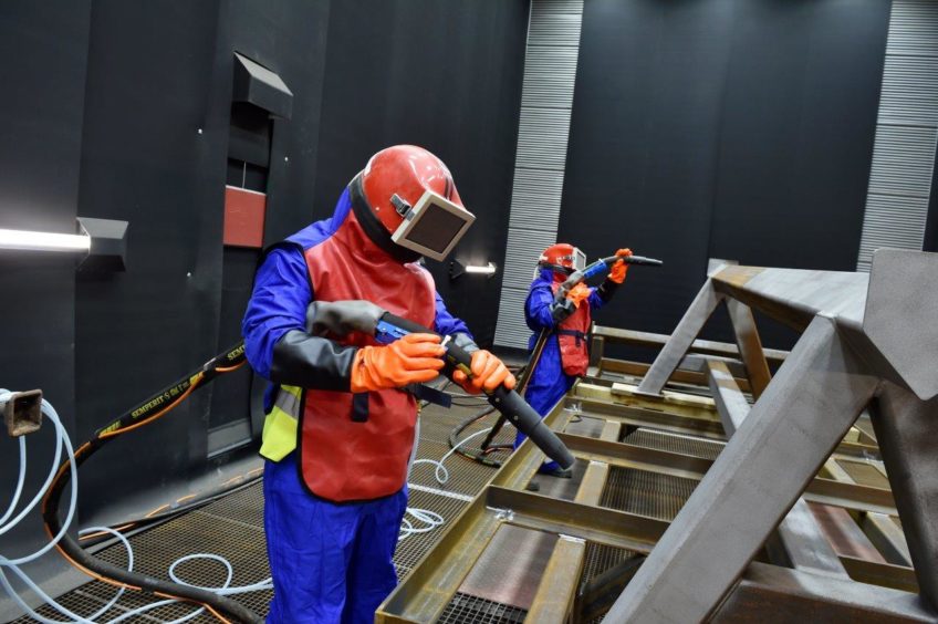 Muehlhan Industrial Services employees undertaking surface blasting.