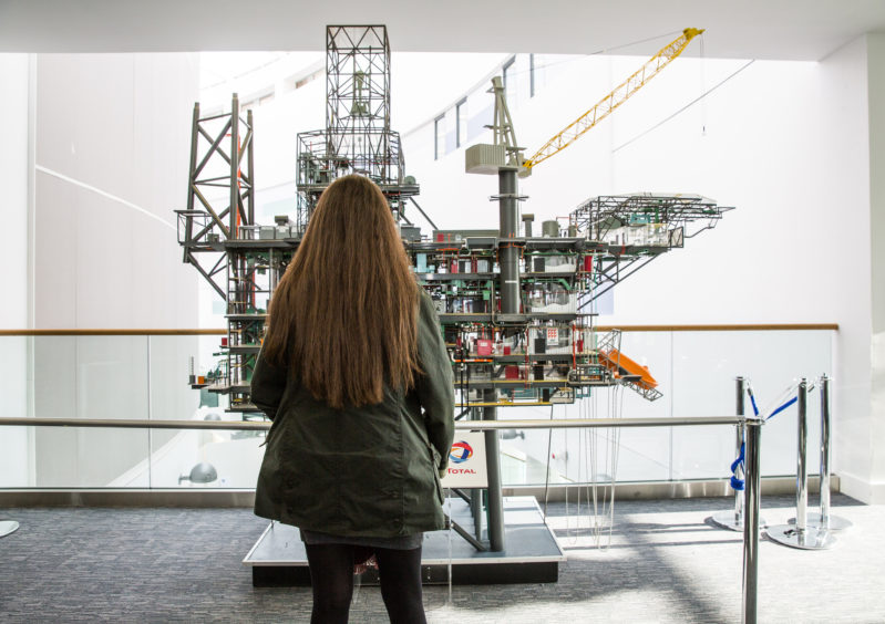 FOI figures show applications for oil and gas courses are making a comeback following a steep drop. Pictured:  A student stands in front of a replica of the Alwyn North platform at RGU's Sir Ian Wood building.  Credit: RGU.