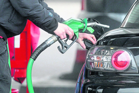 A person using a petrol pump.
