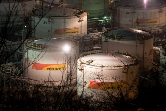 Lights illuminate oil storage tanks at night at the RN-Tuapsinsky refinery, operated by Rosneft Oil Co., in Tuapse, Russia, on Sunday, March 22, 2020. Major oil currencies have fallen much more this month following the plunge in Brent crude prices to less than $30 a barrel, with Russias ruble down by 15%. Photographer: Andrey Rudakov/Bloomberg