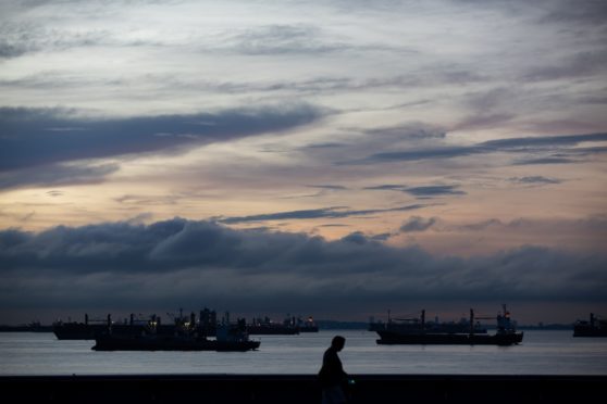 Ships sit moored at sunrise in Singapore, Singapore, on Monday, Feb. 10, 2020. Photographer: Bloomberg/Bloomberg