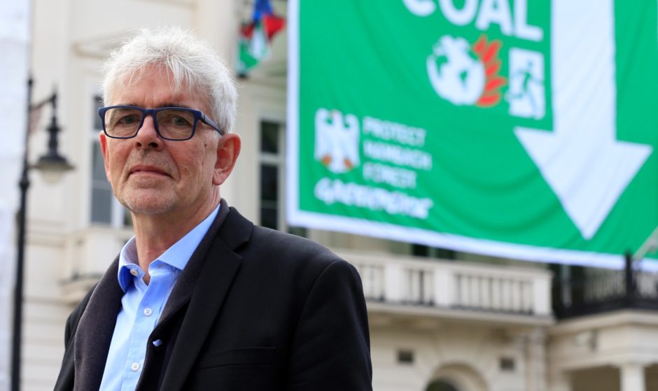 Greenpeace UK executive director John Sauven stands in front of the facade of the German embassy complex in London.