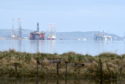 The Cromarty Firth is seeing an increasing number of oil rigs currently in the firth for storage. Photo by Sandy McCook, on April 10, 2020.
