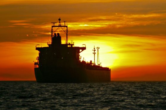An oil tanker is anchored near the Port of Long Beach, California, U.S. Photographer: Tim Rue/Bloomberg