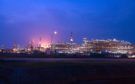 Industrial plant at night against dark blue sky