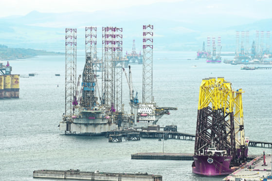 Picture by SANDY McCOOK 15th May '20
A very busy Cromarty Firth as oil rigs are parked up. In the foreground are towers for an offshore windfarm. The tower are at the Global Energy Park at Nigg.
