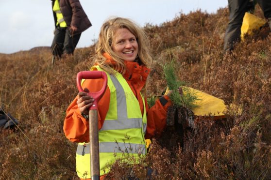 Volunteer Katy with Scots pine seedlings she's about to plant