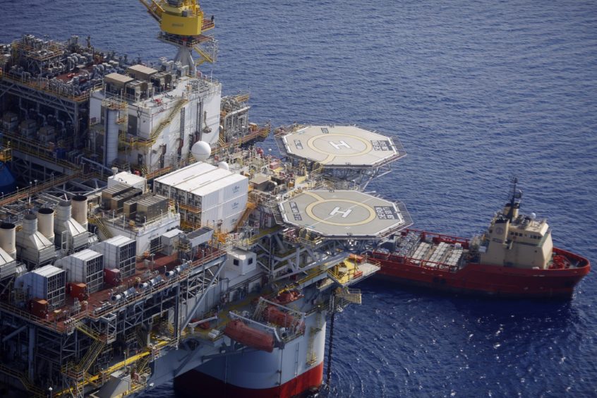 The Kobe Chouest platform supply vessel sits anchored next to the Chevron Corp. Jack/St. Malo deepwater oil platform in the Gulf of Mexico in the aerial photograph taken off the coast of Louisiana, U.S., on Friday, May 18, 2018. While U.S. shale production has been dominating markets, a quiet revolution has been taking place offshore. The combination of new technology and smarter design will end much of the overspending that's made large troves of subsea oil barely profitable to produce, industry executives say. Photographer: Luke Sharrett/Bloomberg