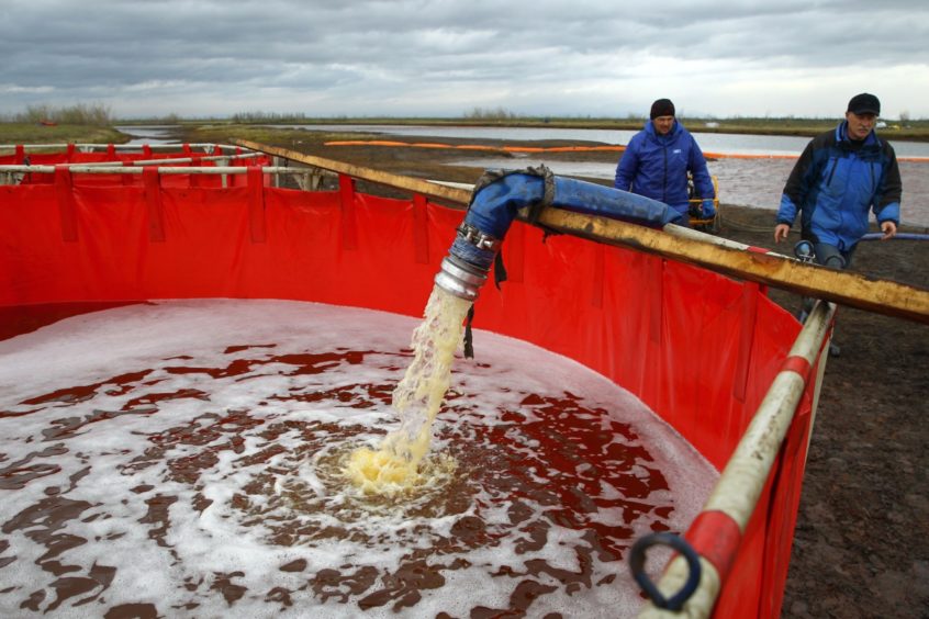 Employees of Russia's state-owned oil pipeline monopoly Transneft take part in a clean-up operation following a massive fuel spill in the Ambarnaya River outside Norilsk on June 10, 2020. Photographer: Irina Yarinskaya/AFP/Getty Images