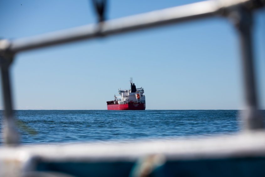 Stowaways from Nigeria are reported to have taken over the Nave Andromeda off the Isle of Wight, with police keeping the vessel under observation.