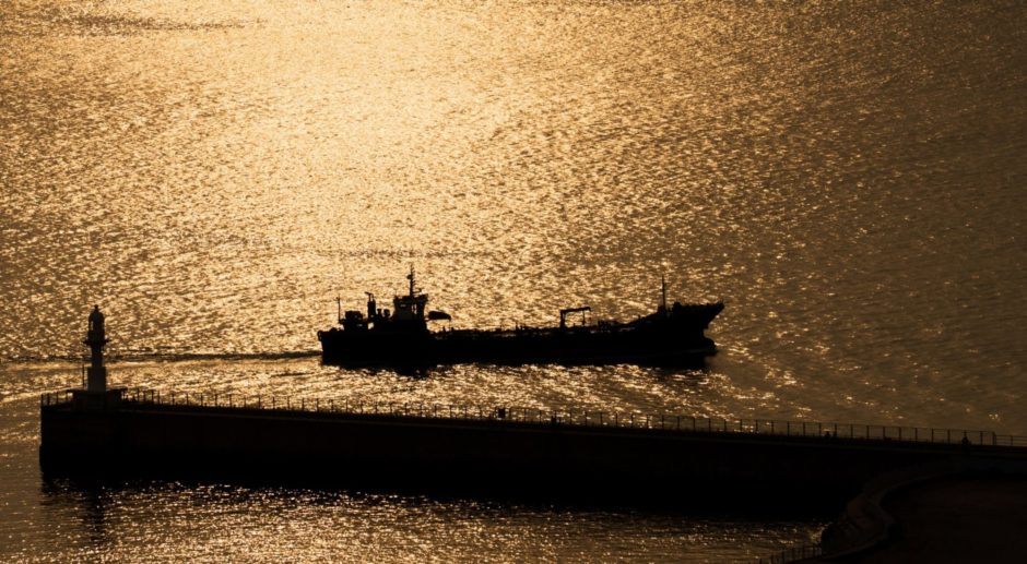 A ship sails past the lighthouse at sunset in the Port of Incheon in Incheon, South Korea, on Monday, Sept. 4, 2017. President Donald Trump said he would discuss the future of the U.S.-South Korea free-trade agreement with his advisers following a newspaper report that hes considering terminating the pact. Photographer: Bloomberg/Bloomberg