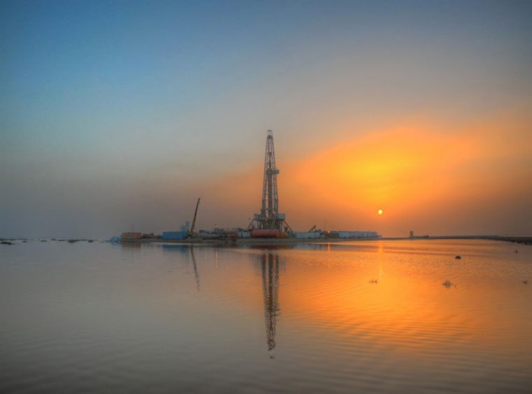 Oil rig against an orange sunset