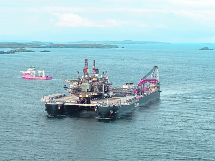 The Ninian Northern Platform arriving in Shetland aboard the world's largest construction vessel, the Pioneering Spirit. Shetland. Courtesy Rory Gillies / Shetland Flier Aerial Media.