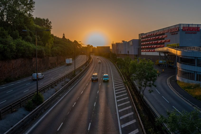 Traffic travels along the M60 motorway past the Redrock leisure development as the sun rises in Stockport, U.K., on Monday, June 22, 2020. The Brexit-supporting regions that propelled Prime Minister Boris Johnson into power are now being disproportionately hit by coronavirus and will bear the brunt of the economic fallout. Photographer: Anthony Devlin/Bloomberg