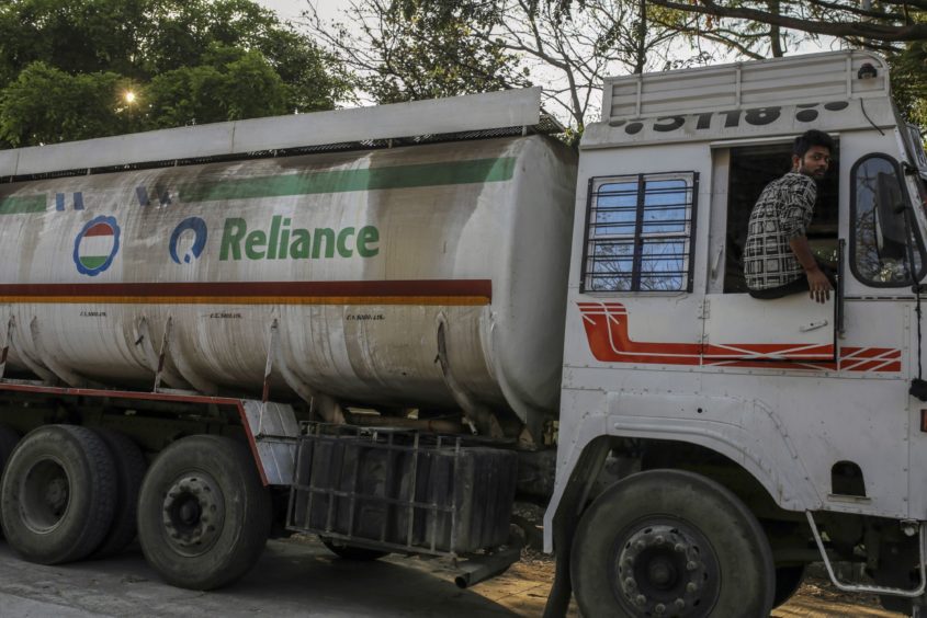 A Reliance Industries Ltd. oil tanker trucks sit parked near Jawaharlal Nehru Port, operated by Jawaharlal Nehru Port Trust (JNPT), in Navi Mumbai, Maharashtra, India, on Monday, March 30, 2020.  Photographer: Dhiraj Singh/Bloomberg