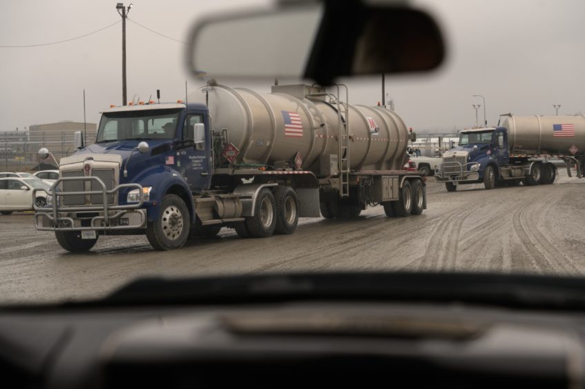 Trucks leave the MarkWest Energy plant in Cadiz, Ohio, U.S., on Tuesday, Feb. 25, 2020. Many Rust Belt voters rely on oil and natural gas jobs and they're wary of Democratic proposals, such as the "Green New Deal," that push for "net-zero emissions" and would effectively put coal and other fossil fuels out of business. Photographer: Justin Merriman/Bloomberg