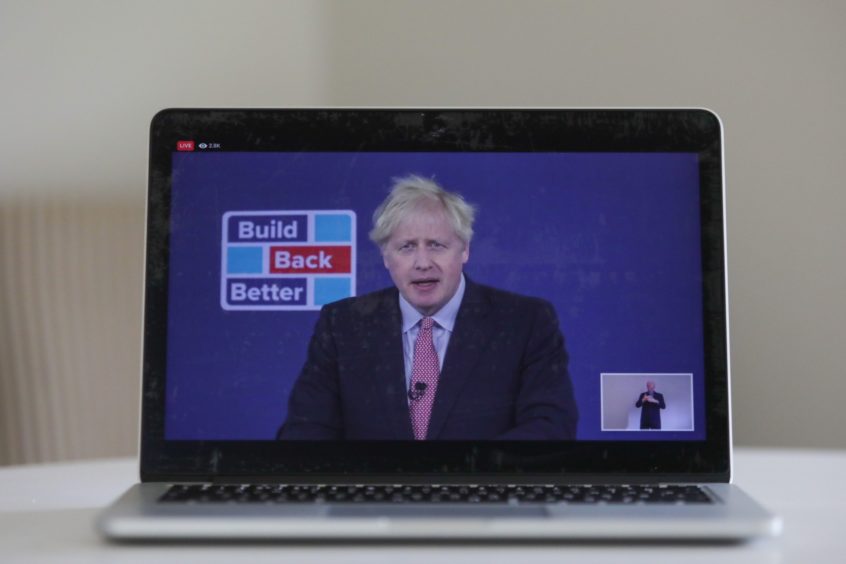 A laptop displays a live broadcast by U.K. Prime Minster Boris Johnson delivering his leader's keynote speech at the Conservative Party virtual conference in this arranged photograph in Danbury, U.K., on Tuesday, Oct. 6, 2020. Johnson will commit to boosting U.K. offshore wind power as part of his delayed plan for a "green industrial revolution" as he seeks to get his stalled domestic agenda back on course. Photographer: Chris Ratcliffe/Bloomberg