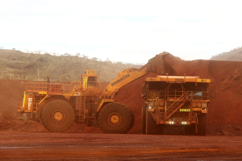 An excavator loads ore into an autonomous dump truck at Fortescue Metals Group Ltd.'s Solomon Hub mining operations in the Pilbara region, Australia, on Thursday, Oct. 27, 2016. Shares in Fortescue, the world's No. 4 iron ore exporter, have almost trebled in 2016 as iron ore recovered, and the company cut costs and repaid debt. Photographer: Brendon Thorne/Bloomberg