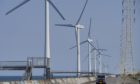 A vehicle drives past wind turbines operated by Wind Power Group KK in Kamisu, Ibaraki Prefecture, Japan, on Wednesday, April 29, 2020.Photographer: Toru Hanai/Bloomberg
