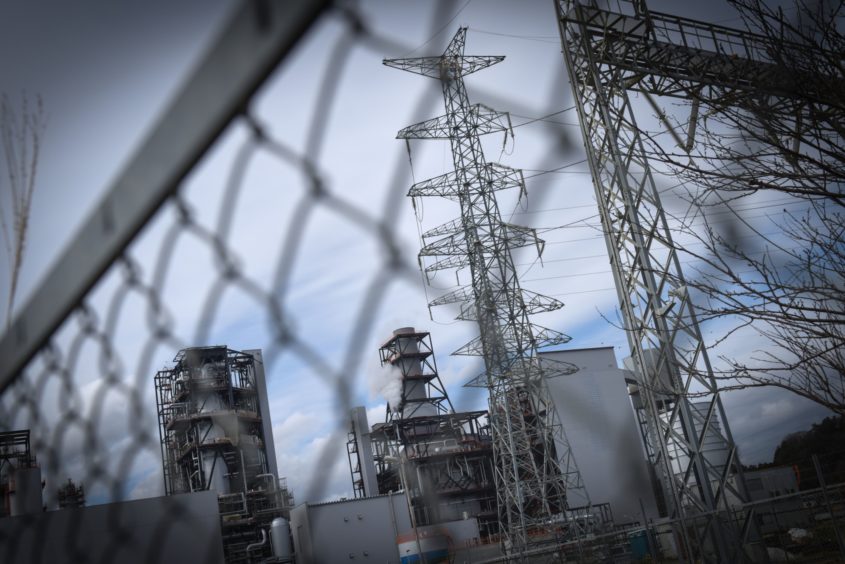 The Nakoso IGCC Power GK integrated gasification combined-cycle power plant stands behind a fence in Iwaki, Fukushima Prefecture, Japan, on Monday, Feb. 3, 2020. Japan's fossil-fuel crutch that helped the country to keep the lights on after the 2011 nuclear tragedy is making a switch to green energy far harder. Photographer: Noriko Hayashi/Bloomberg