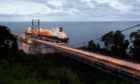 LNG tanker moored with bridge leading to it from right