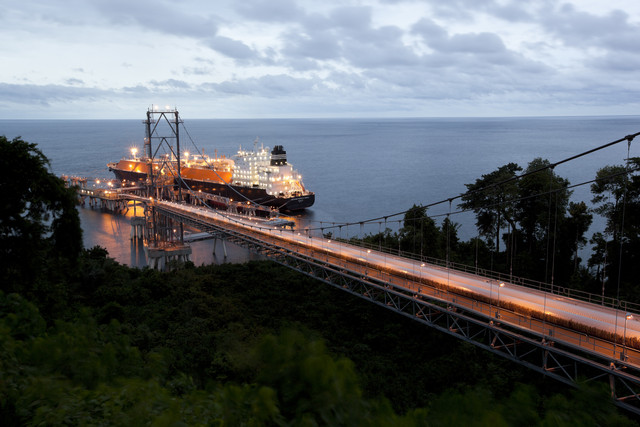 LNG tanker moored with bridge leading to it from right