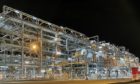 Industrial pipes and lights at night