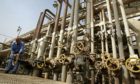 BAGHDAD, IRAQ - NOVEMBER 5: An Iraqi worker adjusts a control valves at the Daura oil refinery on November 5, 2009 in Baghdad, Iraq. (Photo by Muhannad Fala'ah/Getty Images)