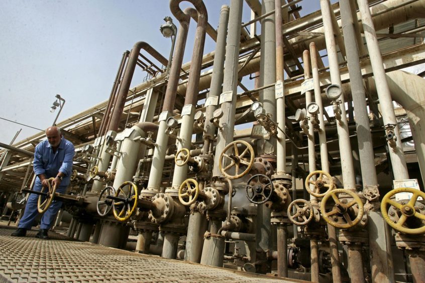 BAGHDAD, IRAQ - NOVEMBER 5: An Iraqi worker adjusts a control valves at the Daura oil refinery on November 5, 2009 in Baghdad, Iraq.  (Photo by Muhannad Fala'ah/Getty Images)