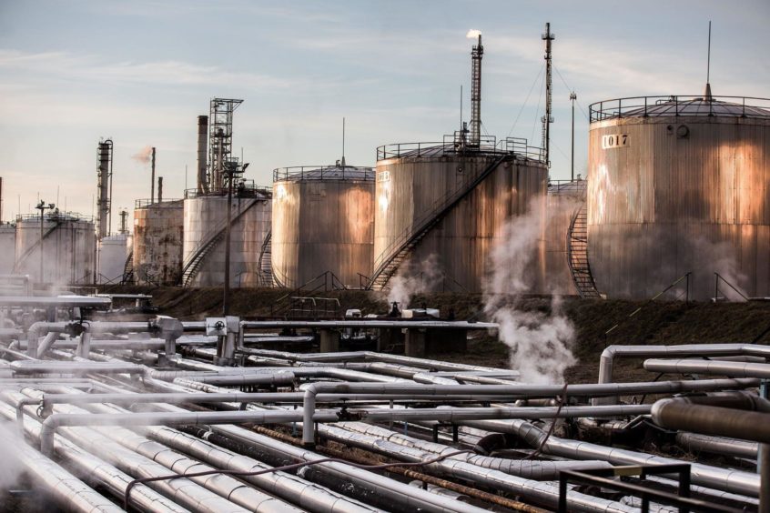 Storage tanks stand at the Duna oil refinery operated by MOL Hungarian Oil & Gas Plc in Szazhalombatta, Hungary. Photographer: Akos Stiller/Bloomberg. Hungary.