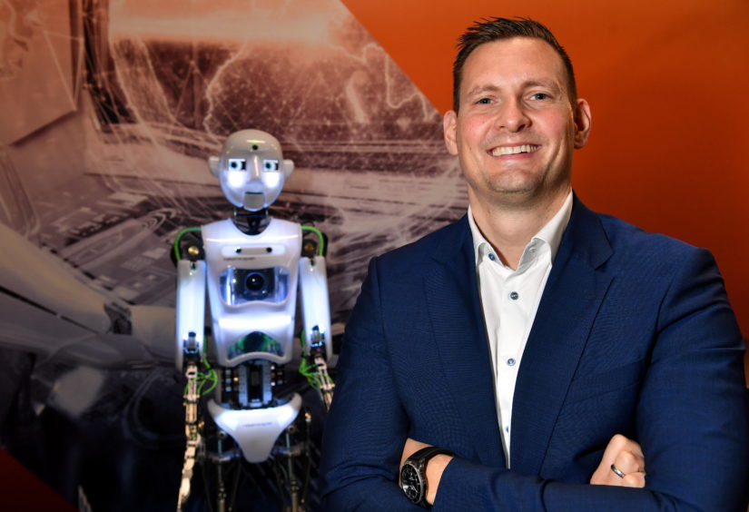 Arne Gürtner of Equinor with the RoboThespian humanoid at Aberdeen Science Centre. Picture by Kami Thomson