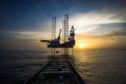 A jack-up rig silhouetted against the sky