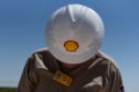 A logo is displayed on the hardhat of a worker at the Royal Dutch Shell Plc processing facility in Loving, Texas, U.S., on Friday, Aug. 24, 2018.