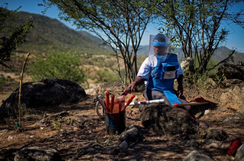 KANENGUERERE, ANGOLA - HALO deminer Beatriz Chawayaca checks her lane for anti-personnel mines in Kanenguerere.  The area was mined during the civil war by government forces to protect the nearby railway line, as well as various troop positions.