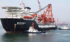 Departure of China National Offshore Oil Corp. (CNOOC)'s first independent deep-water oil drilling rig, from the port of Qingdao, east China's Shandong province. Photographer: Getty Images/AFP