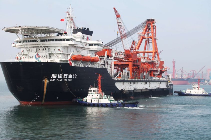 Departure of China National Offshore Oil Corp. (CNOOC)'s first independent deep-water oil drilling rig, from the port of Qingdao, east China's Shandong province.  Photographer: Getty Images/AFP