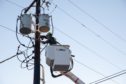 A worker repairs a power line in Austin, Texas, U.S., on Saturday, Feb. 20, 2021. Restaurants in Texas are throwing out expired food, grocery stores are closing early amid stock shortages and residents are struggling to find basic necessities as a cold blast continues to upend supply chains. Photographer: Thomas Ryan Allison/Bloomberg